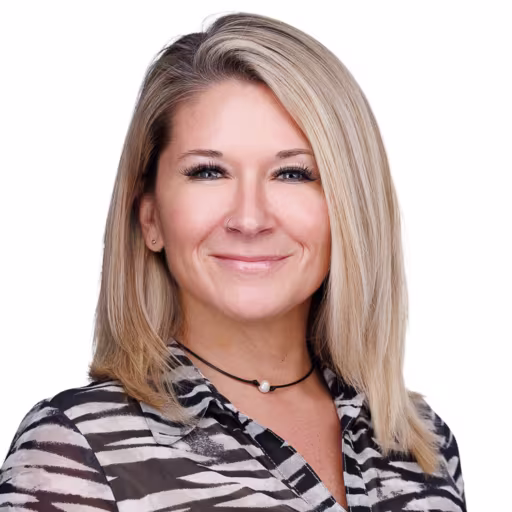 headshot of Angela Crutchfield, wearing a stripped blouse