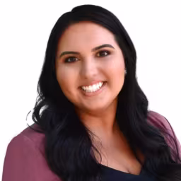 headshot of Annie Herdman, wearing a red blouse