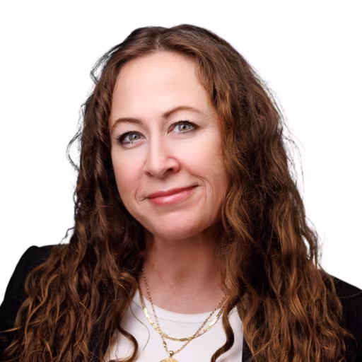 headshot of Aubra Grumley, wearing a black blazer witgh a white shirt