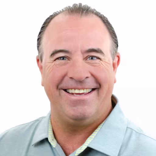 headshot of Mike Behrens, wearing a light green polo