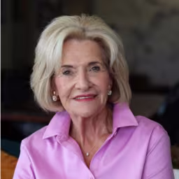headshot of Betty Burch, wearing a bright pink blouse