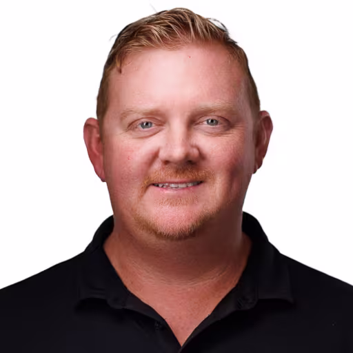 headshot of Brett Cooker, wearing a black polo