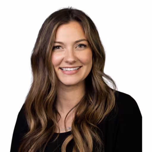 Headshot of Brooke Hines wearing black long sleeved shirt with white background