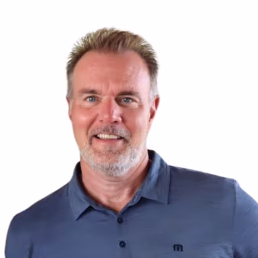 headshot of Bruce Lawing, wearing a dark blue polo