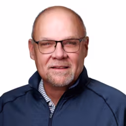 headshot of Butch Bryant, wearing a blue sweater