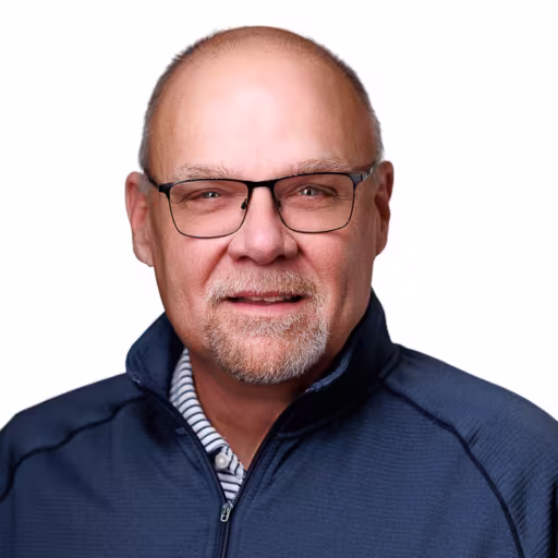 headshot of Butch Bryant, wearing a blue sweater