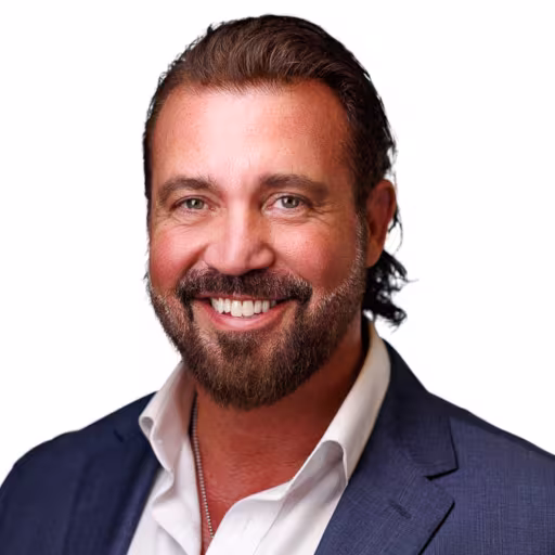 headshot of Chris Galli, wearing a blue suit and a white shirt