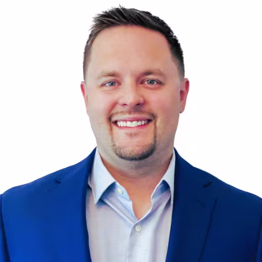 headshot of Coby Matush, wearing a blue suit with a light blue shirt