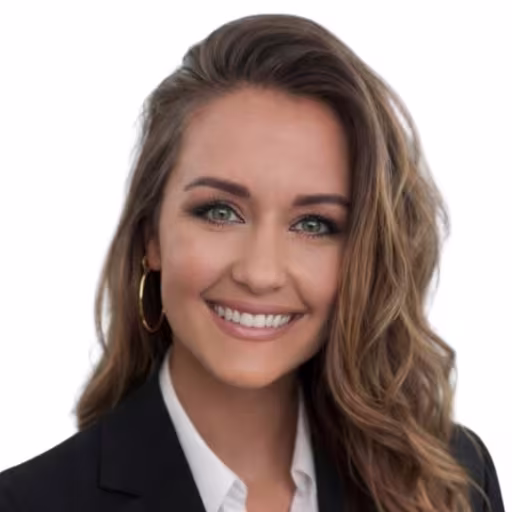 Headshot of Courtney Love, wearing a black blazer and white shirt
