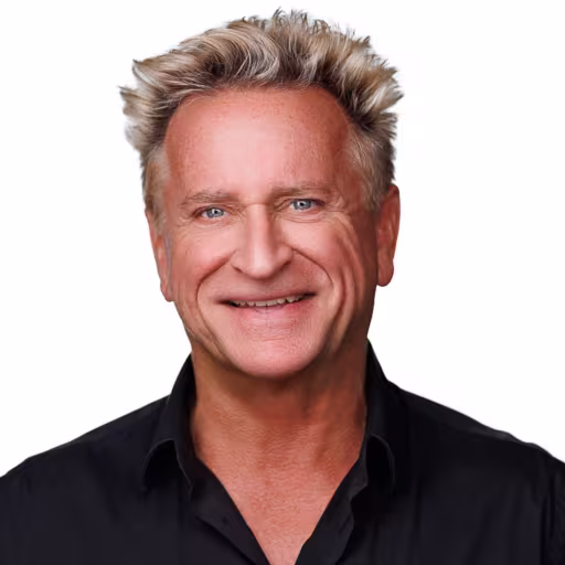 headshot of Craig Warner, wearing a black polo