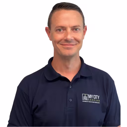 Headshot of Doug Searles wearing navy blue polo shirt with white background