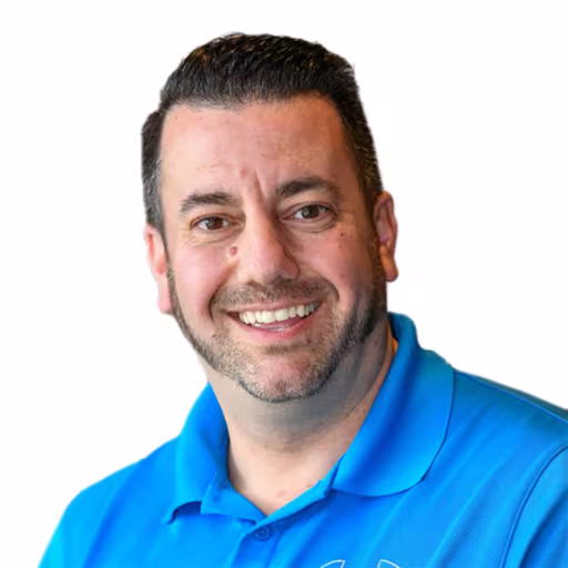Headshot of Frank Bedenik wearing blue shirt with white background