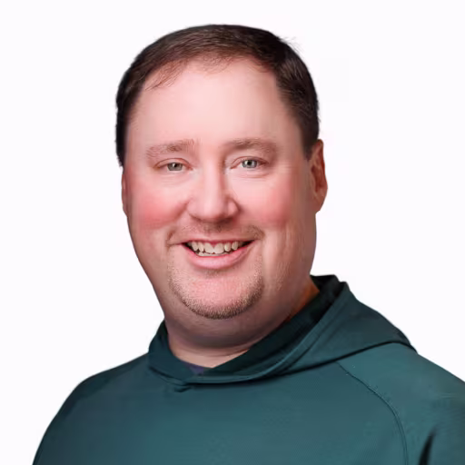 headshot of Hunter Gilmore, wearing a green sweater