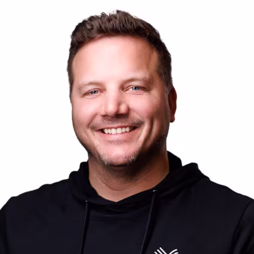 headshot of Jake Schoemann, wearing a black Novus sweatsuit