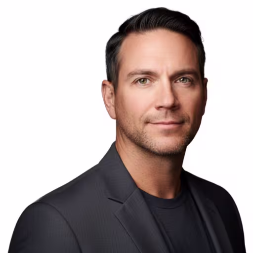 Jason Wiggins headshot. Wearing a dark grey blazer and shirt.