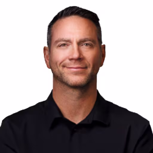 headshot of Jason Wiggins, wearing a black shirt