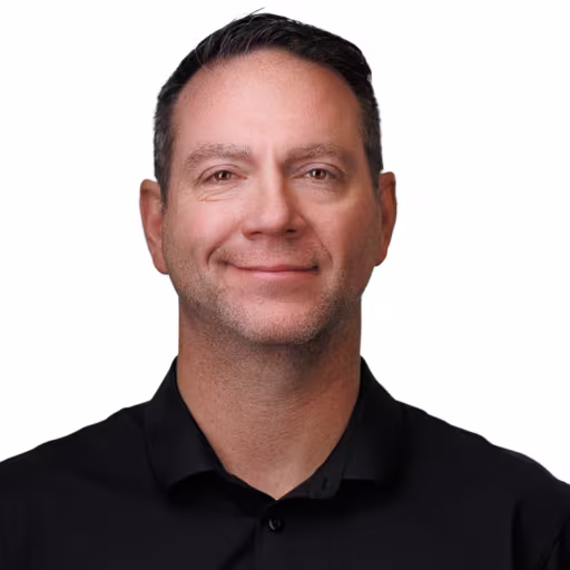 headshot for Jason Wiggins, wearing a black polo