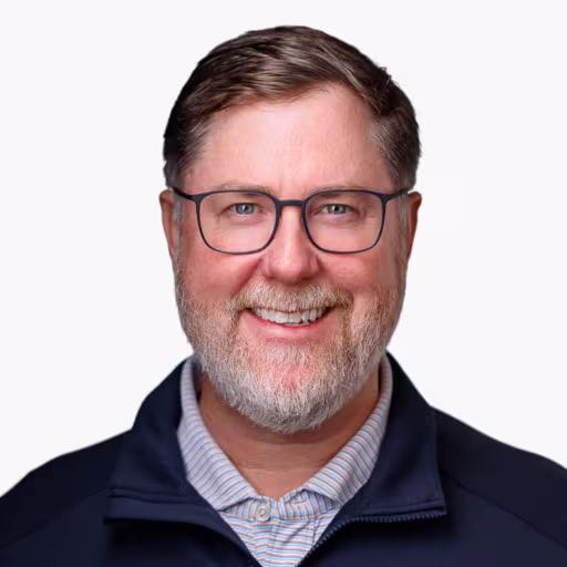 headshot of Jeff Gilmore, wearing a dark blue sweater with a light blue shirt