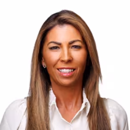 headshot of Jenna Gonzalez, wearing a white blouse