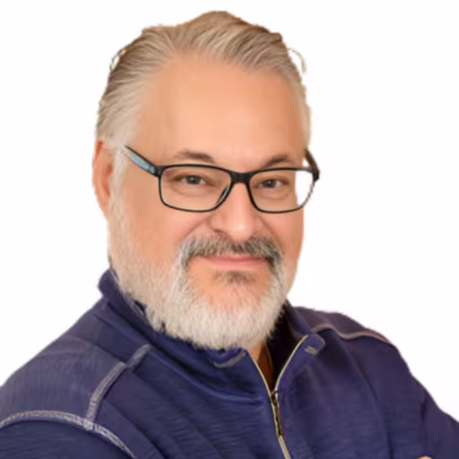 headshot of Joe Duran, wearing a blue sweater