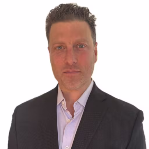 headshot of Joesph Chester, wearing a gray suit