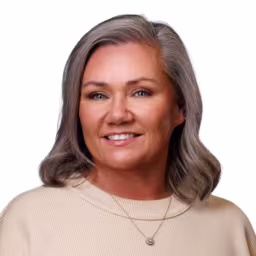 headshot of Johnnie Watson, wearing a cream sweater