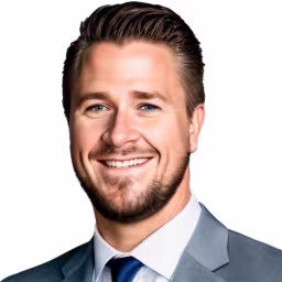 headshot of Jordan Leonhard, wearing a grey suit