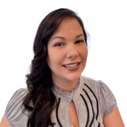 headshot of Kari Pastrana, wearing a grey shirt