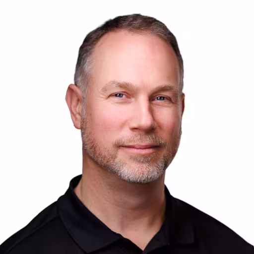 headshot of Keith Radonis, wearing a black polo