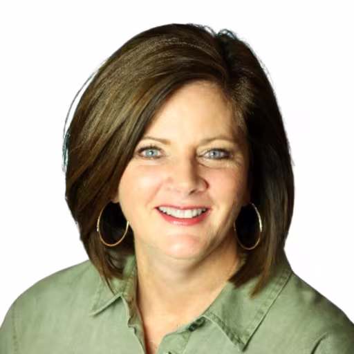 headshot of Kim Sherrell, wearing a green shirt
