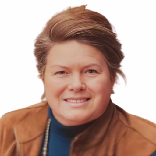 headshot of Lisa Glisson, wearing a brown suit jacket
