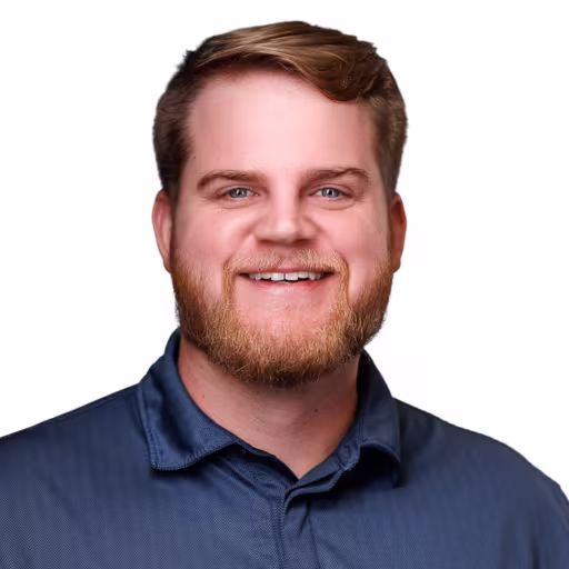 headshot of Logan Hoffman, wearing a blue polo