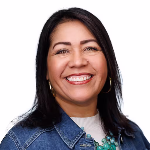 Headshot of Michelle Rojas wearing white shirt and jean jacket with white background