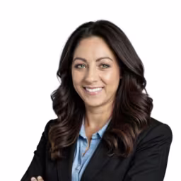 headshot of Misty Canipe, wearing a black blazer with a blue shirt