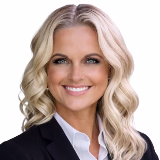 headshot of Paula Mezzanotte, wearing a black suit with a white blouse