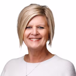 headshot of Renae Dietrich, wearing a white shirt