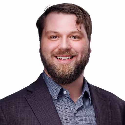 headshot of Richard Bellows, wearing a grey suit with a light grey shirt