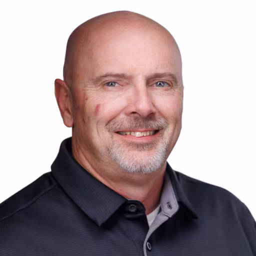 headshot of Rory Broome, wearing a dark grey polo