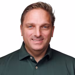 headshot of Ryan DiPietro, wearing a green polo