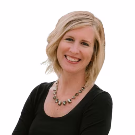 Headshot of Sharon Moser wearing a black blouse and necklace