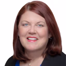 headshot of Susan Dewar, wearing a black shirt