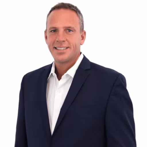 headshot of Tim Hoban, wearing a dark blue suit