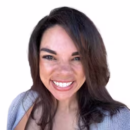 Headshot of Tori Mays wearing light blue sweater with white background