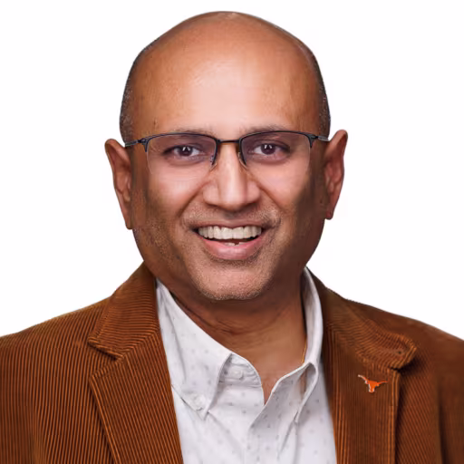 headshot of Upen Patel, wearing an orange, brown suit with a white shirt
