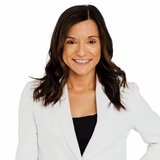 headshot of Andrea Lawler, wearing a white suit and black blouse