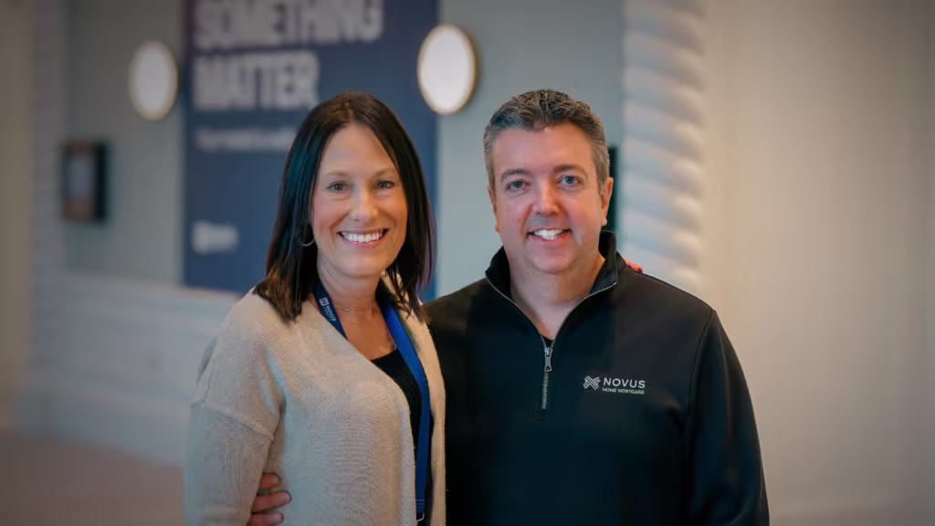 Photo of Eric Egenhoefer and Kerry Wirth from the Novus Executive team, standing in a conference hall.