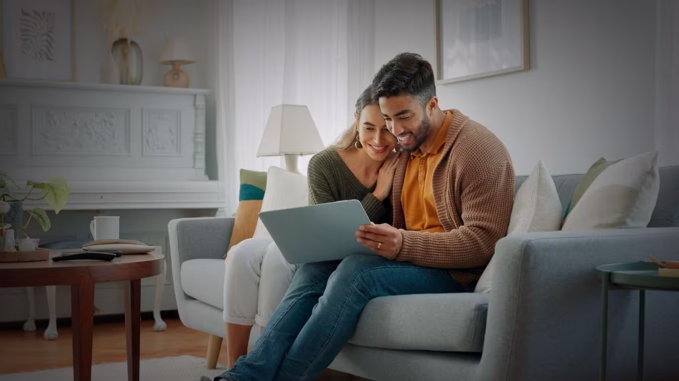 Laptop, living room and couple search website information for home investment, loan or real estate property discussion on sofa.