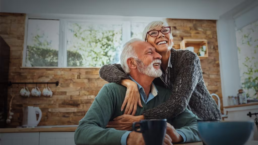 happy older couple, hugging in a kitchen