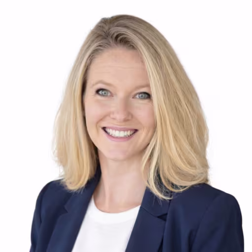 Headshot of Brittany Chaney, wearing a dark blue blazer and white shirt