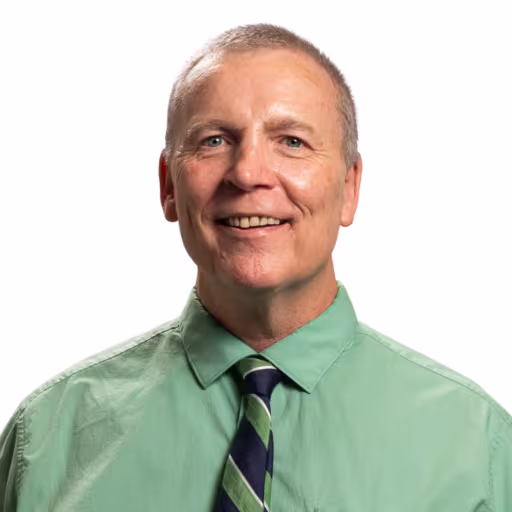Photo of man wearing green shirt with tie